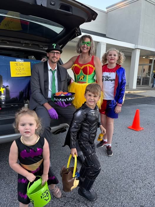 Family dressed in Halloween costumes at a West Georgia fall festival and trunk or treat